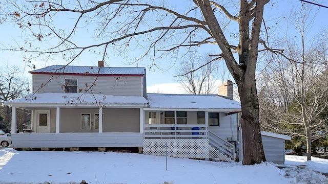 snow covered house with a porch