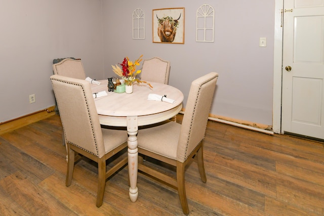 dining space with dark wood-type flooring