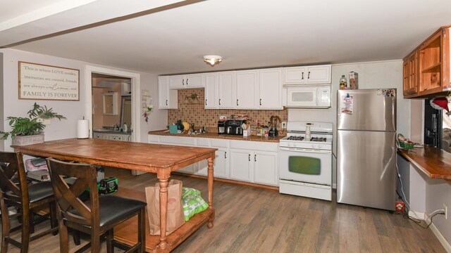 kitchen featuring tasteful backsplash, white cabinets, dark wood-type flooring, and white appliances