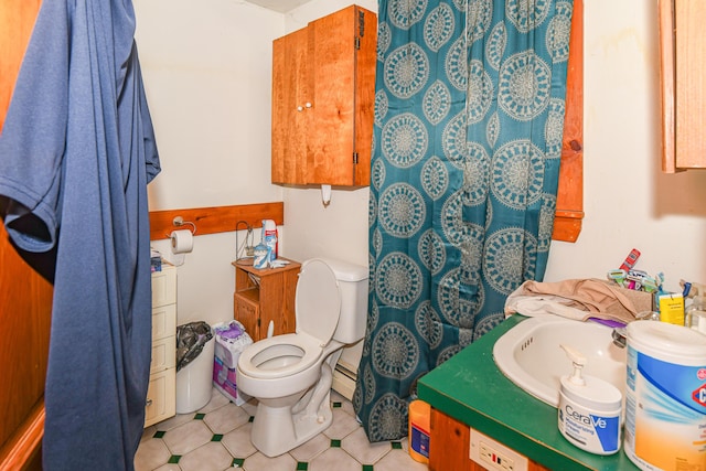 bathroom with vanity, toilet, and a baseboard radiator