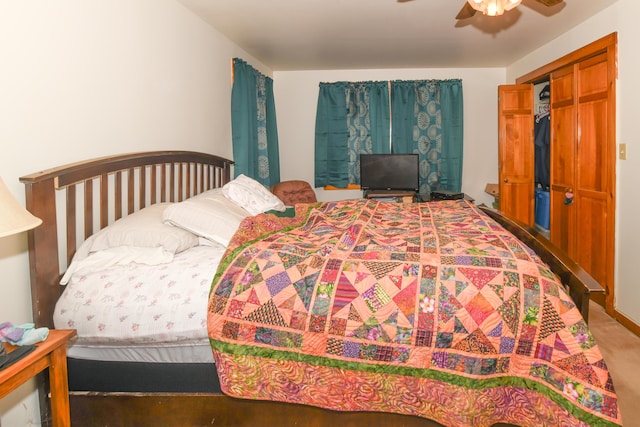 bedroom with ceiling fan and a closet