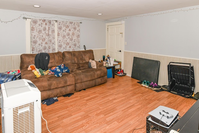 living room with wood-type flooring and wooden walls