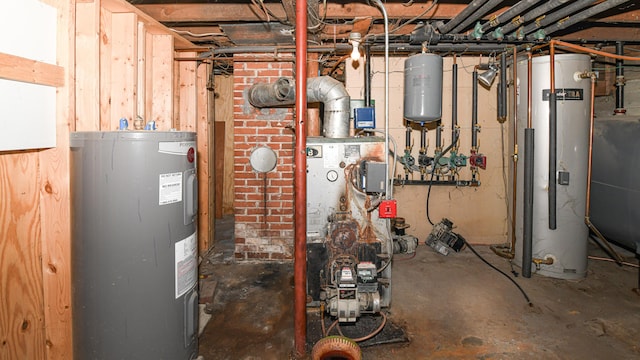 utility room featuring electric water heater and gas water heater