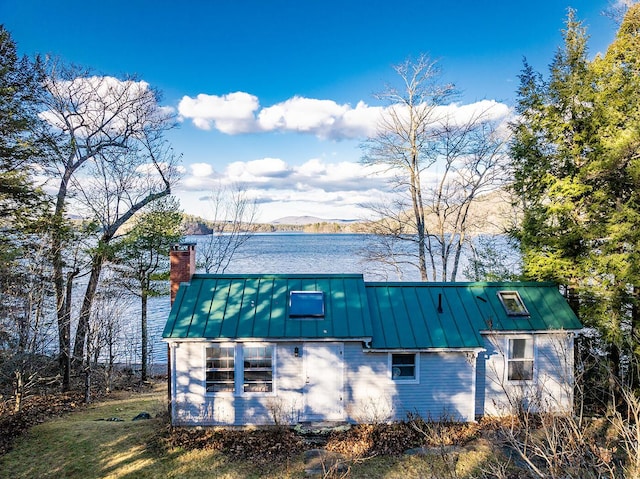 view of property exterior with a water and mountain view