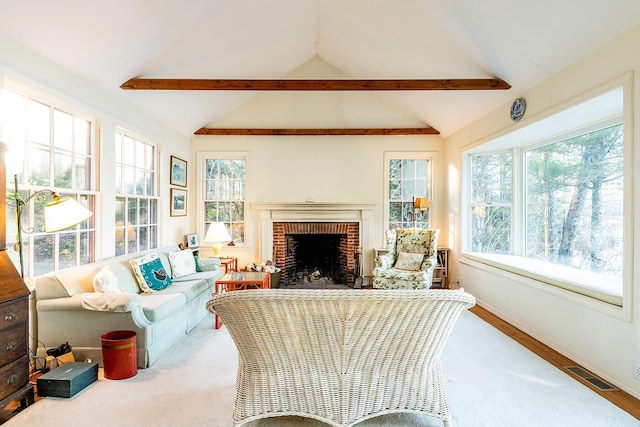 sunroom / solarium featuring a fireplace and lofted ceiling with beams