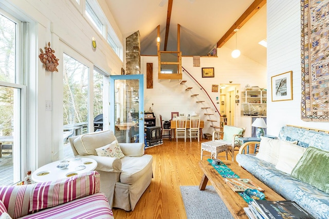 living room featuring plenty of natural light, high vaulted ceiling, hardwood / wood-style floors, and beamed ceiling