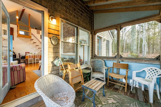 sunroom / solarium with lofted ceiling with beams