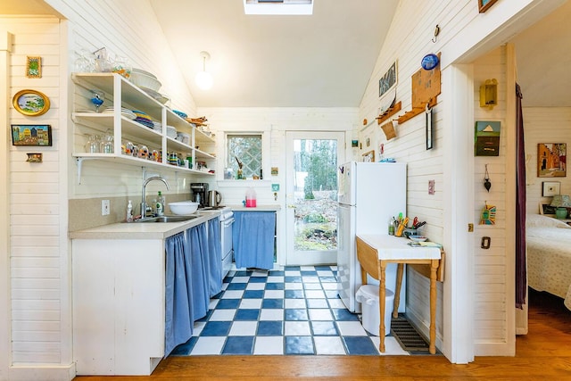 161 Beaucaire Ave, Camden, ME 04843 - kitchen featuring freestanding refrigerator, open shelves, light countertops, wooden walls, and lofted ceiling