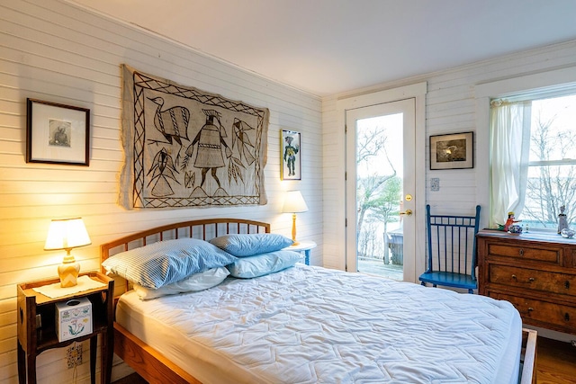 bedroom with access to outside and hardwood / wood-style flooring