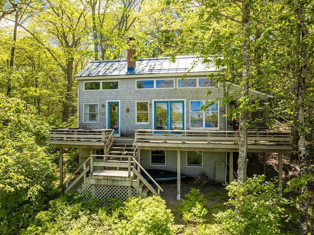 161 Beaucaire Ave, Camden, ME 04843 - back of property with a standing seam roof, a chimney, stairway, a wooden deck, and metal roof