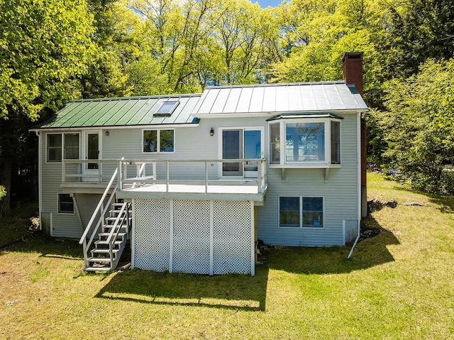 161 Beaucaire Ave, Camden, ME 04843 - rear view of property featuring a standing seam roof, stairs, a lawn, a chimney, and a wooden deck