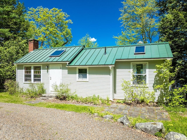 161 Beaucaire Ave, Camden, ME 04843 - view of front of house featuring a standing seam roof, metal roof, and a chimney