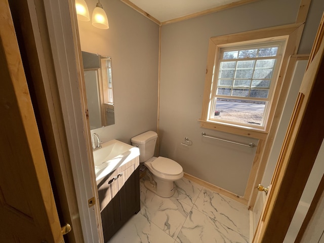 12 Main St, Sanford, ME 04083 - half bathroom featuring vanity, toilet, marble finish floors, crown molding, and baseboards
