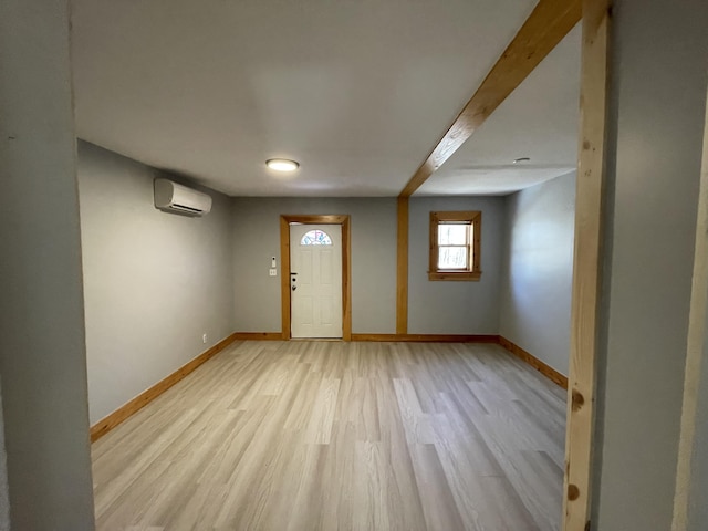 12 Main St, Sanford, ME 04083 - foyer with a wall unit AC, baseboards, and light wood-style floors