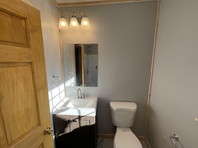 12 Main St, Sanford, ME 04083 - bathroom with toilet, vanity, and baseboards