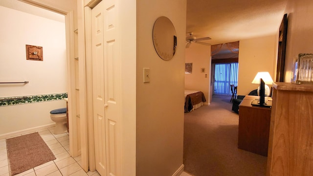 hall with light tile patterned floors