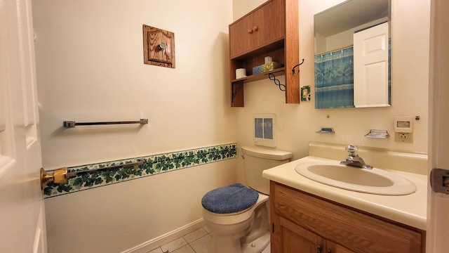 bathroom with tile patterned floors, heating unit, vanity, and toilet