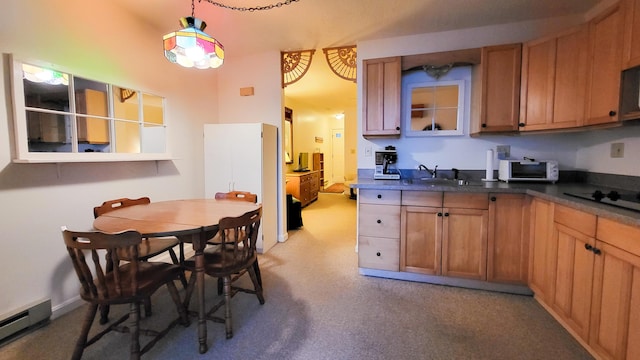 kitchen featuring decorative light fixtures, black electric cooktop, sink, and a baseboard heating unit