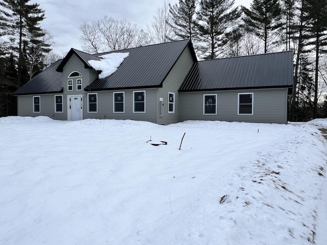 view of snow covered back of property