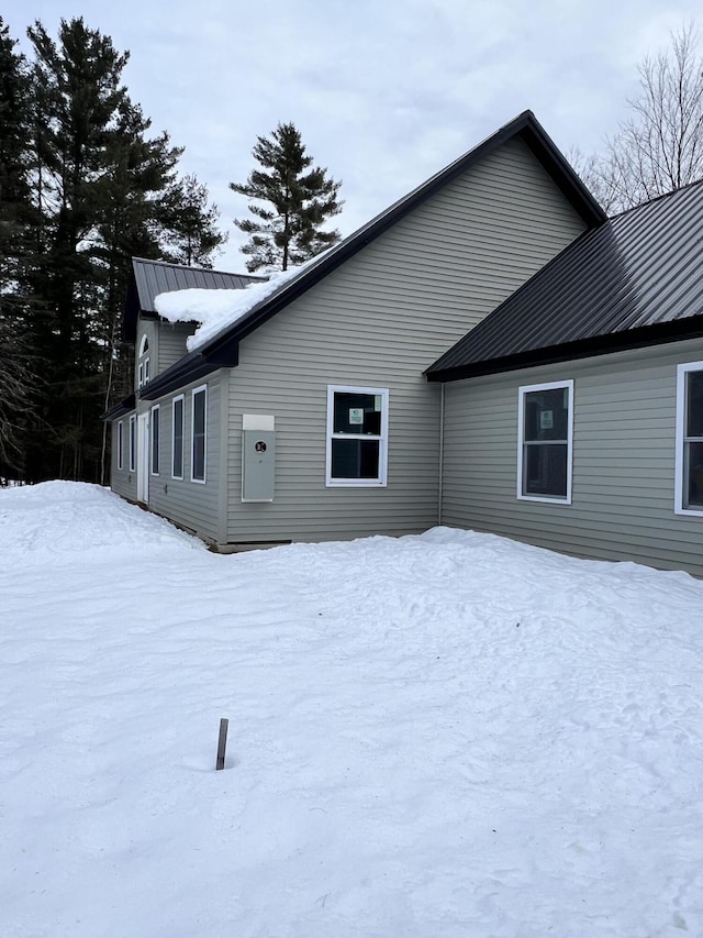 view of snow covered rear of property