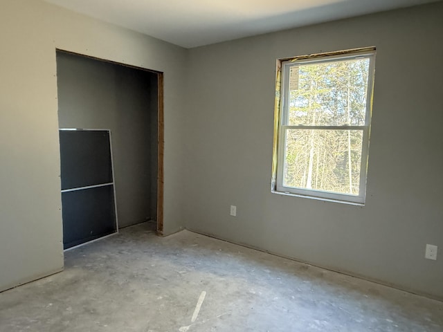 199 Bert Berry Rd, Embden, ME 04958 - unfurnished bedroom with concrete flooring