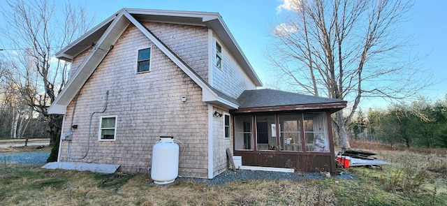 rear view of property with a sunroom