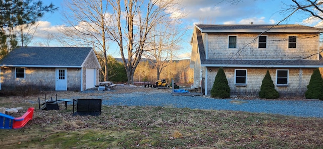 view of side of home featuring a mountain view, a garage, and an outdoor structure