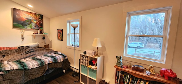 bedroom with wood-type flooring and baseboard heating