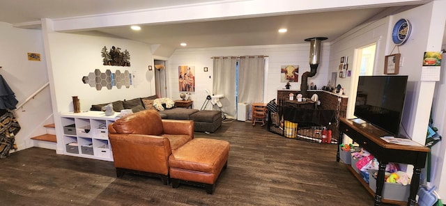 living room featuring dark wood-type flooring and wood walls