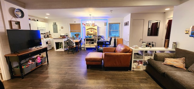 living room featuring a chandelier, dark hardwood / wood-style flooring, electric panel, and beamed ceiling