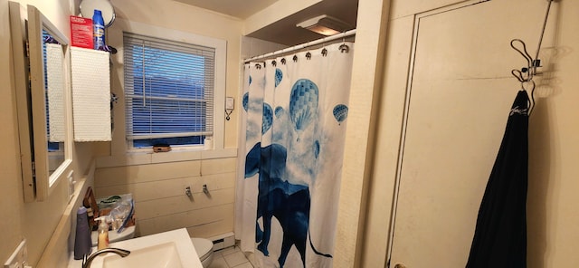 bathroom with tile patterned flooring, toilet, and walk in shower