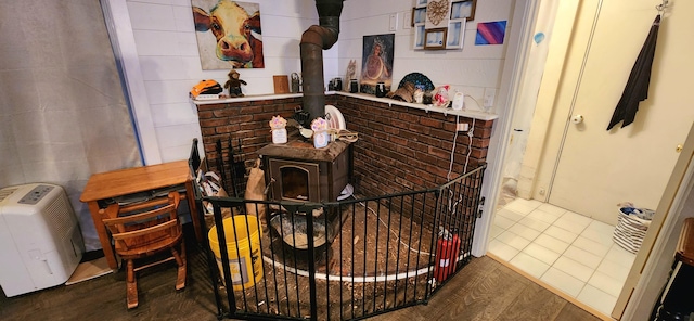 details featuring a wood stove and hardwood / wood-style floors