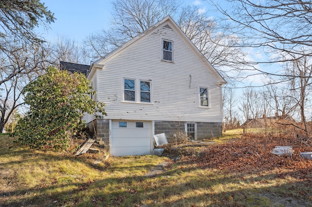 back of house with roof with shingles and a yard