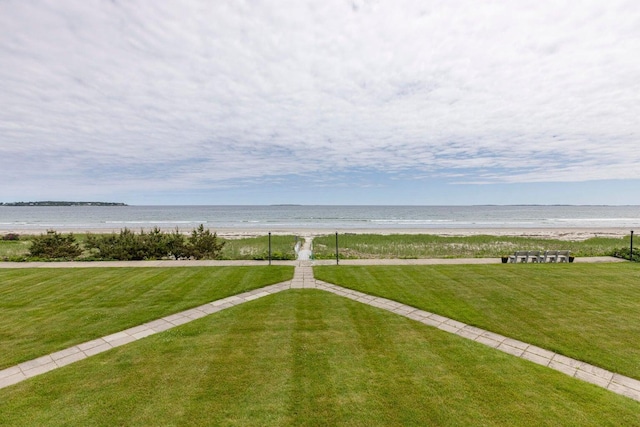 view of yard featuring a water view and a view of the beach