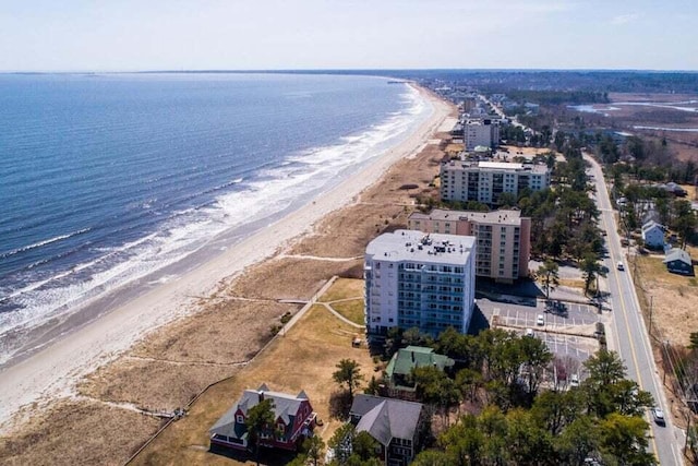 bird's eye view with a water view and a beach view