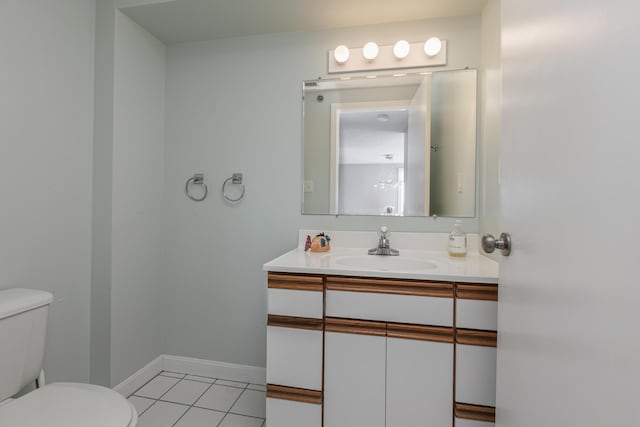 bathroom featuring tile patterned floors, vanity, and toilet