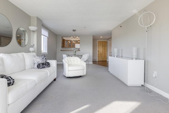 carpeted living room featuring an inviting chandelier