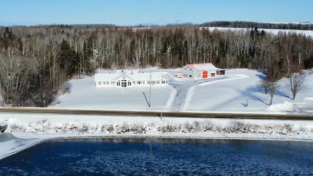 snowy aerial view with a water view