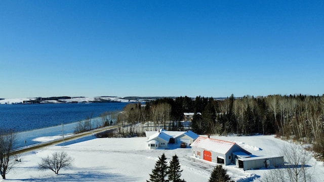 snowy aerial view featuring a water view