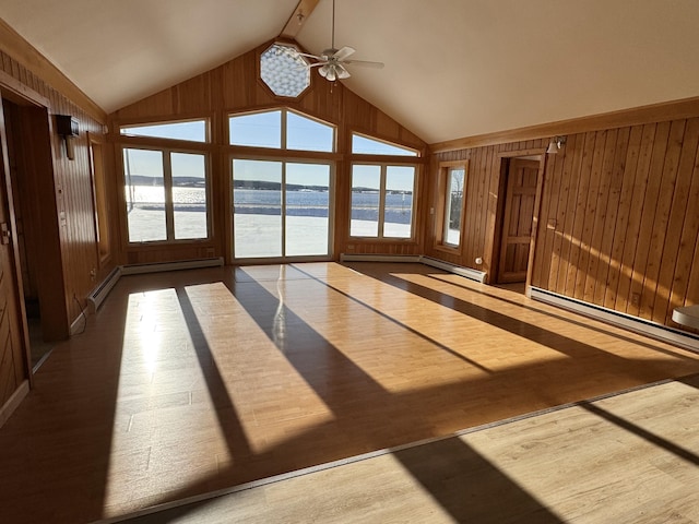 unfurnished sunroom with vaulted ceiling with beams, ceiling fan, a water view, and a baseboard heating unit