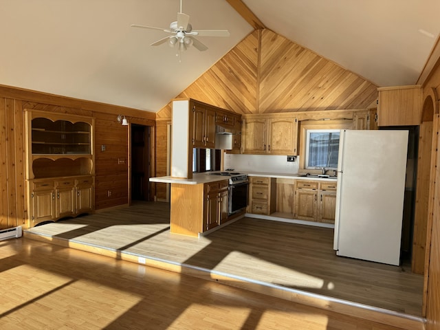 kitchen with kitchen peninsula, wooden walls, white refrigerator, light hardwood / wood-style flooring, and range with electric stovetop