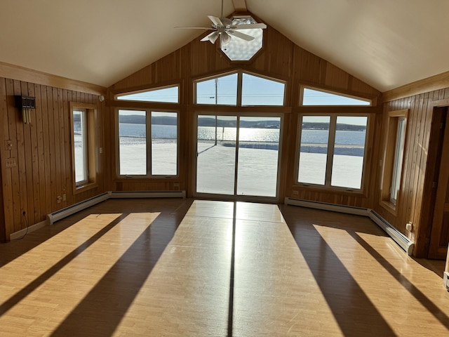 unfurnished sunroom featuring a water view, a wealth of natural light, and ceiling fan