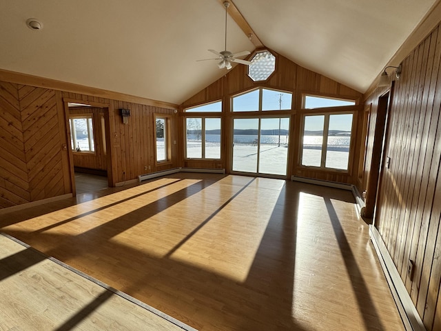 unfurnished sunroom with plenty of natural light, ceiling fan, a water view, and a baseboard radiator