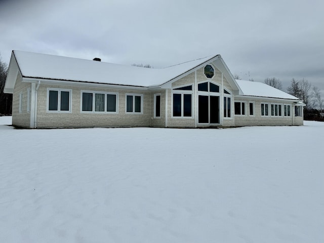 view of snow covered rear of property