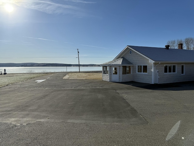 view of front of property with a water view