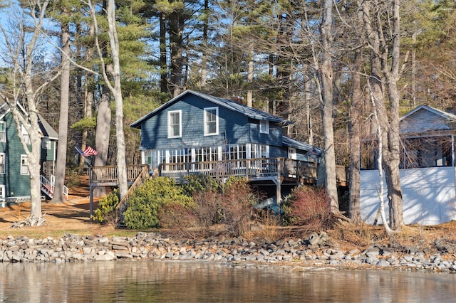 back of property with a deck with water view