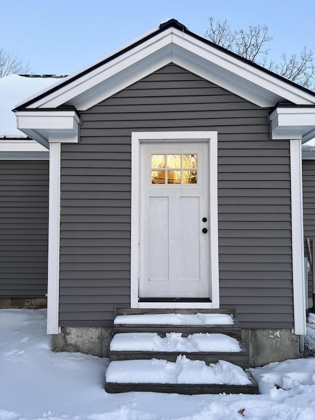 view of snow covered property entrance