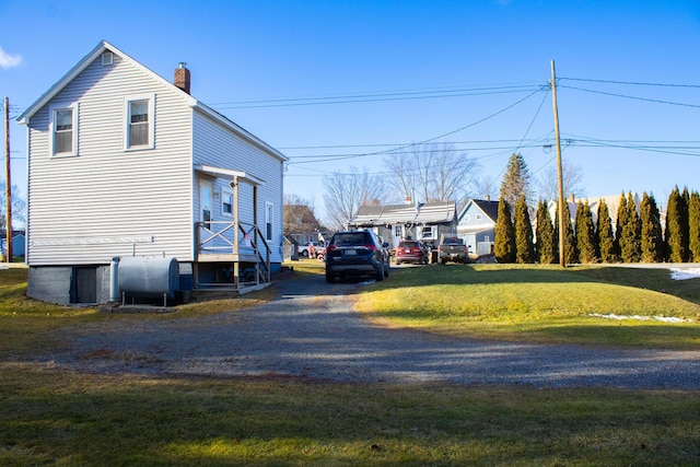 view of side of property with a lawn