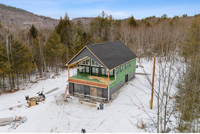 exterior space featuring a wooded view