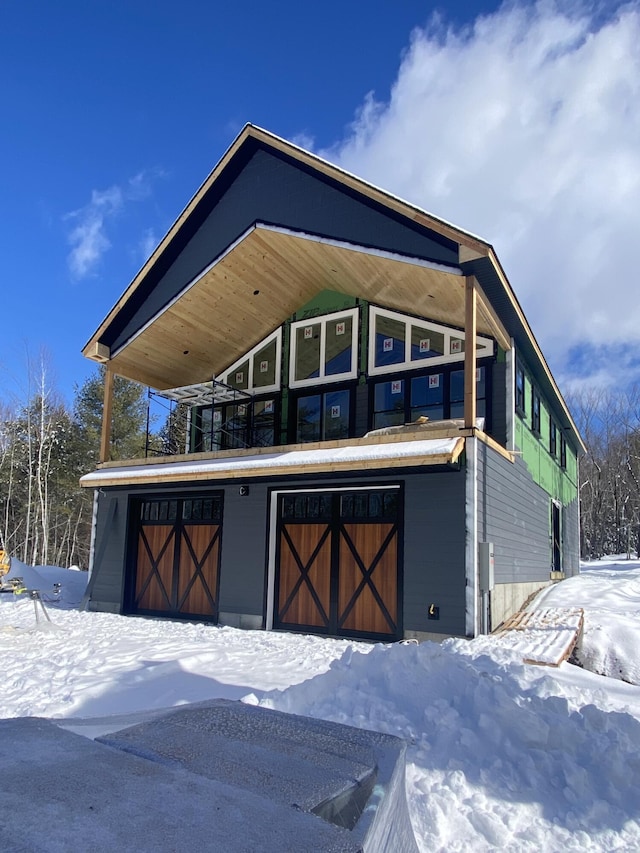 view of front of house featuring a garage and an outdoor structure